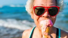 Older lady at beach eating ice cream